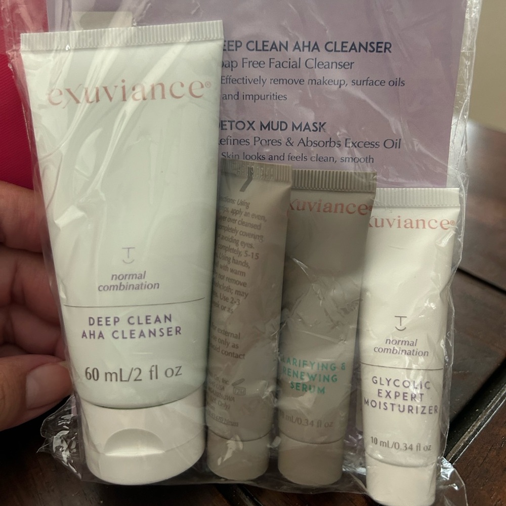 Pink cosmetic bag with Exuviance sample beauty products.